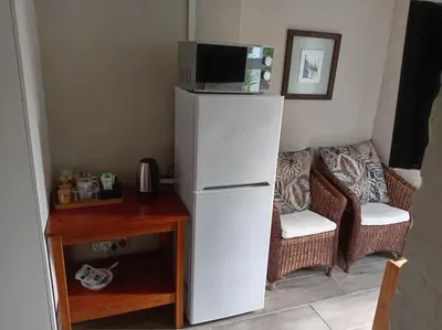 a white refrigerator with a microwave on top of it at Hermanus 13 on 2nd Guest Rooms in Hermanus