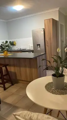 a kitchen with a table and a counter top at Modest Home in Cape Town in Cape Town