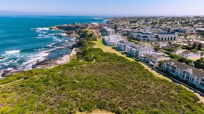 an aerial view of a beach with houses and the ocean at Seaside Serenity: Tranquil Oceanview Retreat in Hermanus
