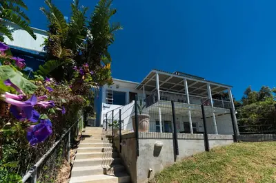 a house with stairs leading up to it at 'BoStrand' - Private and Central, only 2 min walk to beach - sleeps 2 in Gordonʼs Bay