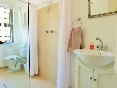 a bathroom with a sink and a toilet and a shower at 'Terrace-On-Sea'- 2 Min from the beach, 2 bedroom town house, Sleeps 4 in Cape Town