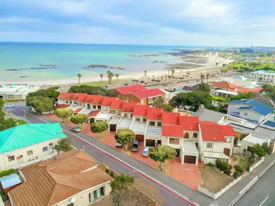 an aerial view of a town with a beach at 'Terrace-On-Sea'- 2 Min from the beach, 2 bedroom town house, Sleeps 4 in Cape Town