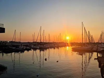 a group of boats parked in a marina at sunset at 'Terrace-On-Sea'- 2 Min from the beach, 2 bedroom town house, Sleeps 4 in Cape Town