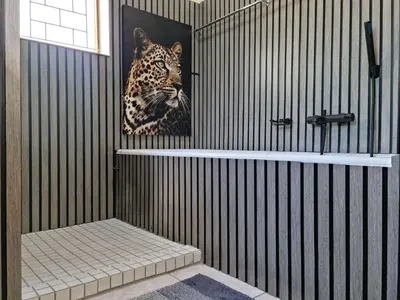a bathroom with a painting of a leopard on the wall at 'The Loft', 2 bedroom, sleeps 4, Central, Fantastic Views! in Cape Town