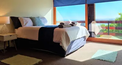 a bedroom with a large bed with a large window at 'The Loft', 2 bedroom, sleeps 4, Central, Fantastic Views! in Cape Town