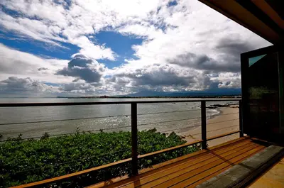 a view of the ocean from a balcony of a house at Driftwood Beach Villa in Gordonʼs Bay