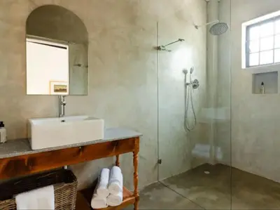 a bathroom with a sink and a shower at Nooitgedacht Guest Farm Cottages in Kayamnandi