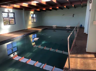 a swimming pool in a room with at Mar-a-Stella Self-Catering Family Retreat in Bettyʼs Bay
