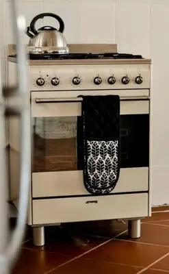 a tea kettle sitting on top of an oven at Mar-a-Stella Self-Catering Family Retreat in Bettyʼs Bay
