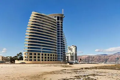 a building on the beach in front of a building at 302 Ocean View in Strand