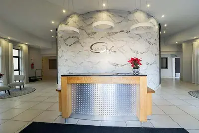 a lobby with a counter with a vase of flowers at 302 Ocean View in Strand