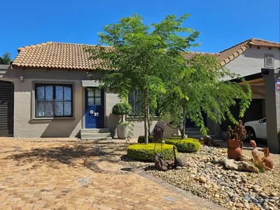 a house with a tree in the front yard at At 37 Masters Way in Brandwacht