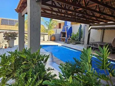 a swimming pool in the middle of a yard at At 37 Masters Way in Brandwacht