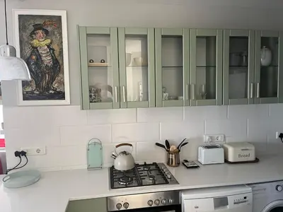 a kitchen with green cabinets and a stove top oven at 502 Hibernian Towers in Cape Town