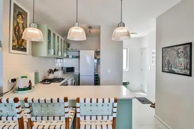a kitchen with a table and chairs in a kitchen at 502 Hibernian Towers in Cape Town