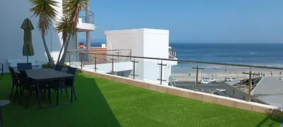 a balcony with a table and a view of the ocean at 502 Hibernian Towers in Cape Town