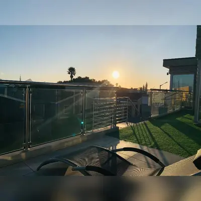 a view of the sunset from the balcony of a house at Kwaaamiii in Cape Town