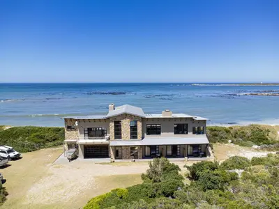 an aerial view of a house on the beach at Hangklip Villa in Pringle Bay