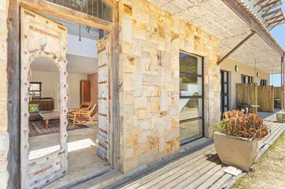 an old building with a stone wall at Hangklip Villa in Pringle Bay