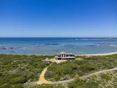 an aerial view of a house on a beach at Hangklip Villa in Pringle Bay