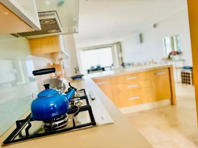 a blue tea kettle on a stove in a kitchen at 74 on Marine - Apartment 303 in Hermanus