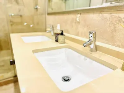 a bathroom with two white sinks in a bathroom at 74 on Marine - Apartment 303 in Hermanus