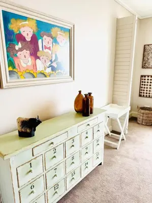 a dresser in a room with a painting on the wall at 74 on Marine - Apartment 303 in Hermanus