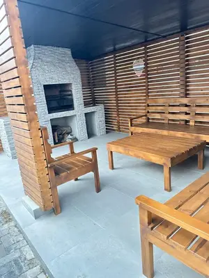 a patio with two benches and a fireplace at Malaika Guest House in Cape Town