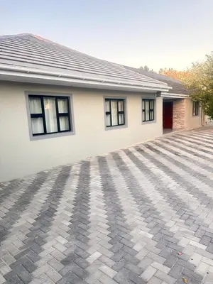 a house with a brick driveway in front of it at Malaika Guest House in Cape Town