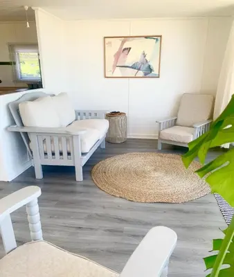 a living room with white furniture and a rug at Fantastic spot In Hermanus with great lagoon views in Hermanus