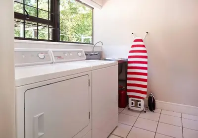 a kitchen with a washing machine and a window at The Oasis of Stellenbosch in Stellenbosch