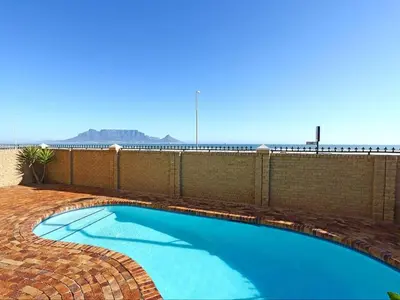 a swimming pool on the side of a building at Zeezicht 204 Bloubergstrand in Bloubergstrand