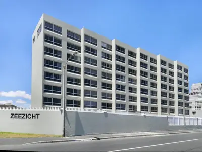 a large white building with a street light in front of it at Zeezicht 204 Bloubergstrand in Bloubergstrand