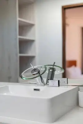 a bathroom counter with a sink and a mirror at Family home in Tableview, close to Dolphin Beach. in Cape Town
