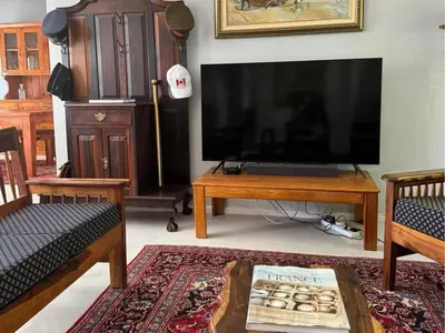 a living room with a large flat screen tv at Bordeaux 45 in Cape Town