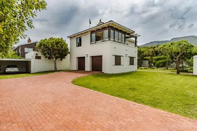 a large white house with a brick driveway at 3 on Vermont in Hermanus