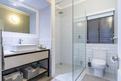 a white bathroom with a sink and a toilet at 3 on Vermont in Hermanus