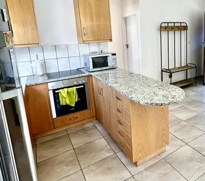 a kitchen with a counter and a stove top oven at Happy Place Pringle Bay for 2 in Pringle Bay
