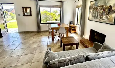 a living room with a couch and a table at Happy Place Pringle Bay for 2 in Pringle Bay
