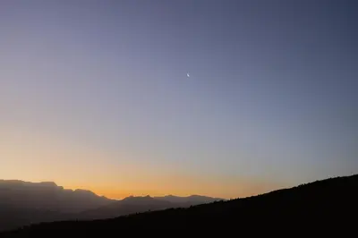 a sunset over the mountains in the distance at Berghuis - Mountain Hideaway in Wolseley