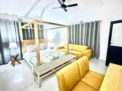 a bedroom with a canopy bed and a couch at Franschhoek - A Sensory Escape in Franschhoek