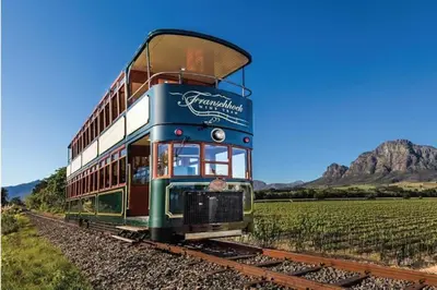 a train on the tracks in a field at Franschhoek - A Sensory Escape in Franschhoek