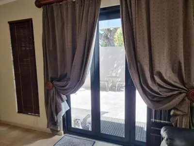 an open door to a patio with curtains at Sunset Getaways in Cape Town