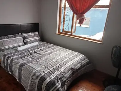 a bed in a bedroom with a window at ATHOME BELLVILLE Chrismar in Cape Town
