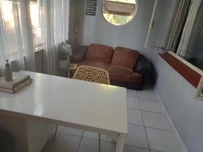 a living room with a couch and a table at ATHOME BELLVILLE Chrismar in Cape Town