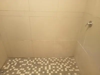 a bathroom with a shower with a checkered floor at ATHOME BELLVILLE Chrismar in Cape Town