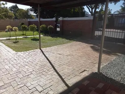 an umbrella on a brick patio in a yard at ATHOME BELLVILLE Chrismar in Cape Town