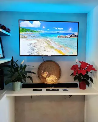 a flat screen tv sitting on top of a shelf at Blissful Country Garden King Bed Cottage in Grabouw