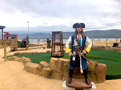 a statue of a man standing on a stand at Benguela Cove - Milk and Honey in Hermanus