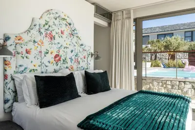 a bedroom with a bed with a large window at Benguela Cove - Lavender Dreams in Hermanus